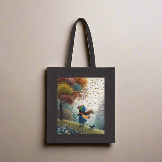 Black tote bag with a colorful design of a person in a blue coat walking a dog in a park.