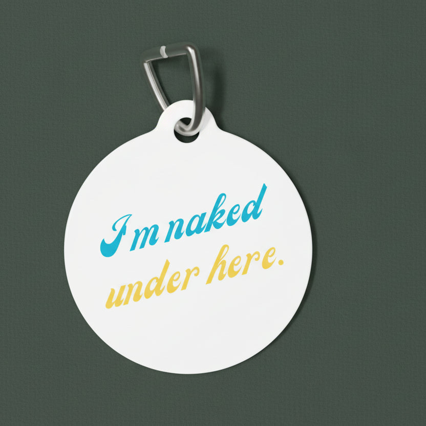 Round white pendant with humorous text 'I'm naked under here' on a white background