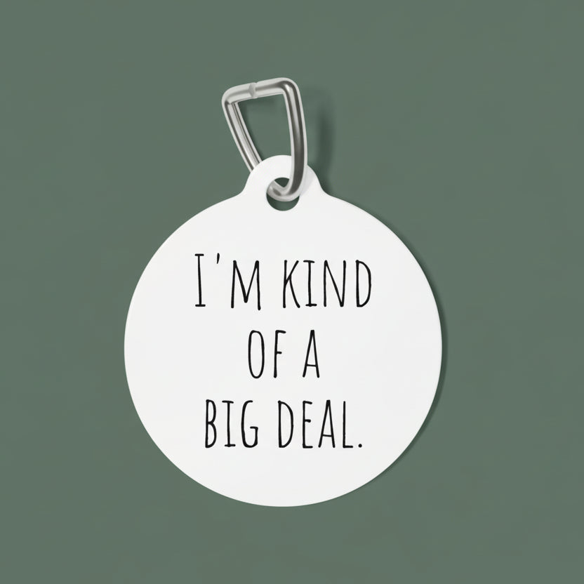 Round white dog tag with 'I'm kind of a big deal' text on a white background
