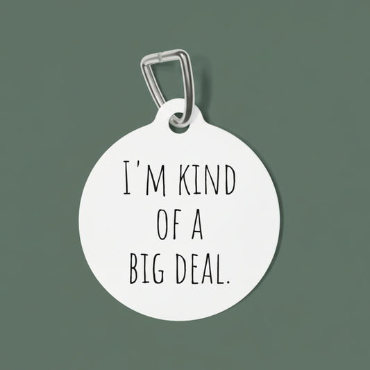 Round white dog tag with 'I'm kind of a big deal' text on a white background