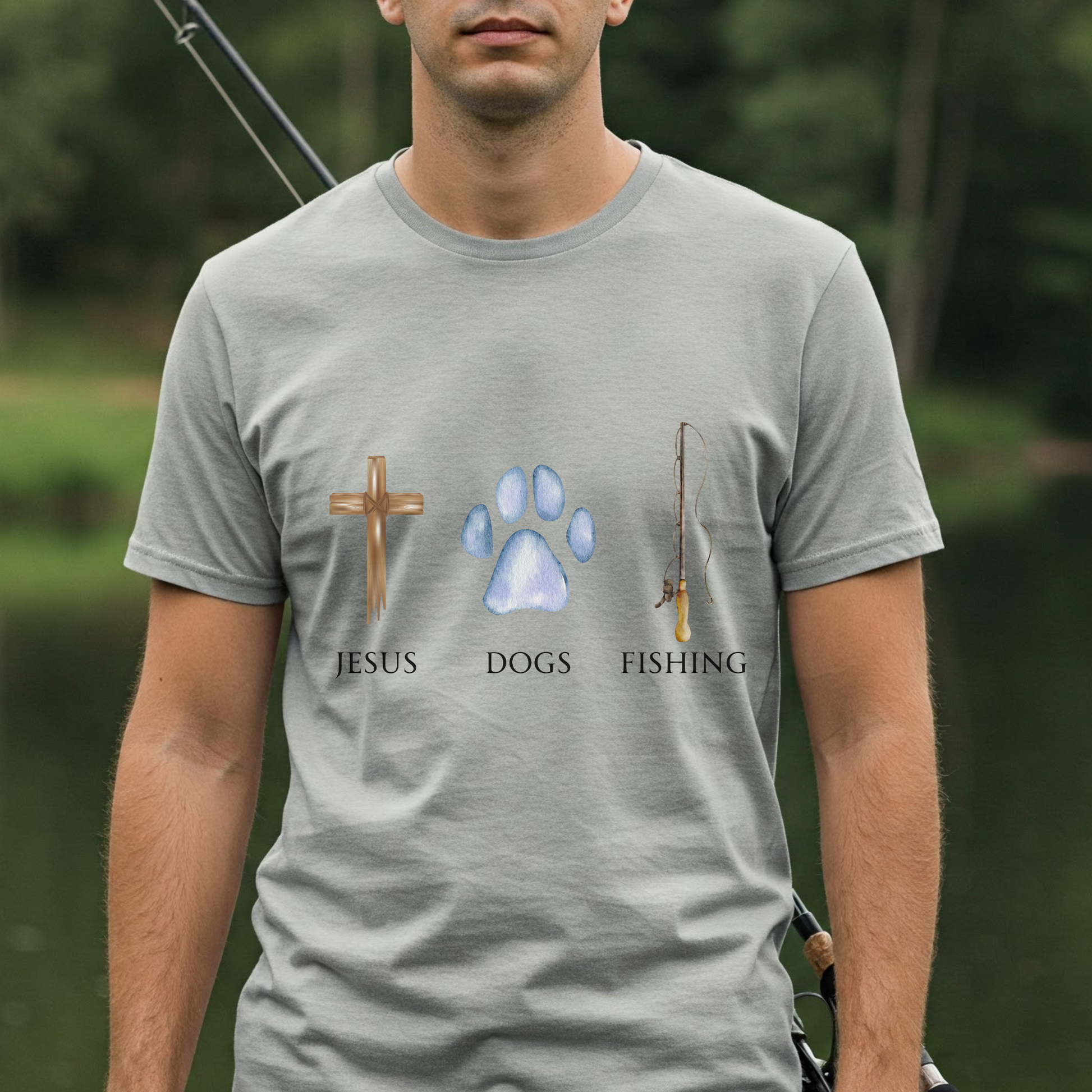 Man wearing a gray t-shirt with 'Jesus Dogs Fishing' design outdoors.