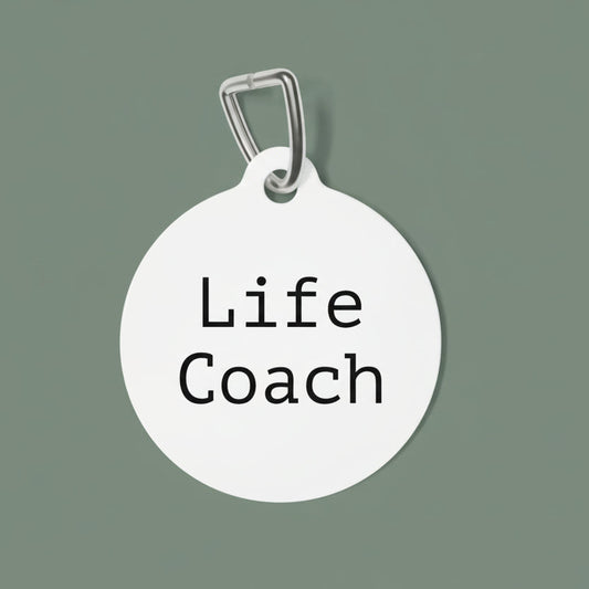 Round white dog tag with 'Life Coach' engraving on a white background