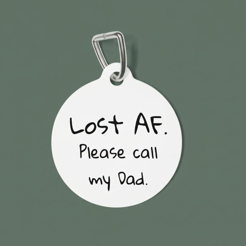 Round white dog tag with black text 'Lost AF. Please call my Dad.' on a white background