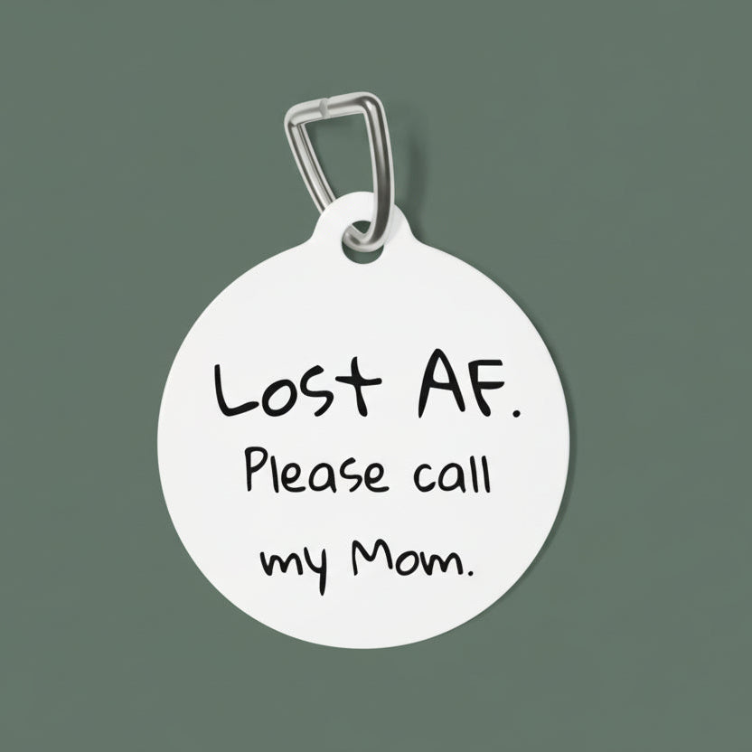 Round dog tag with black text 'Lost AF. Please call my Mom.' on a white background