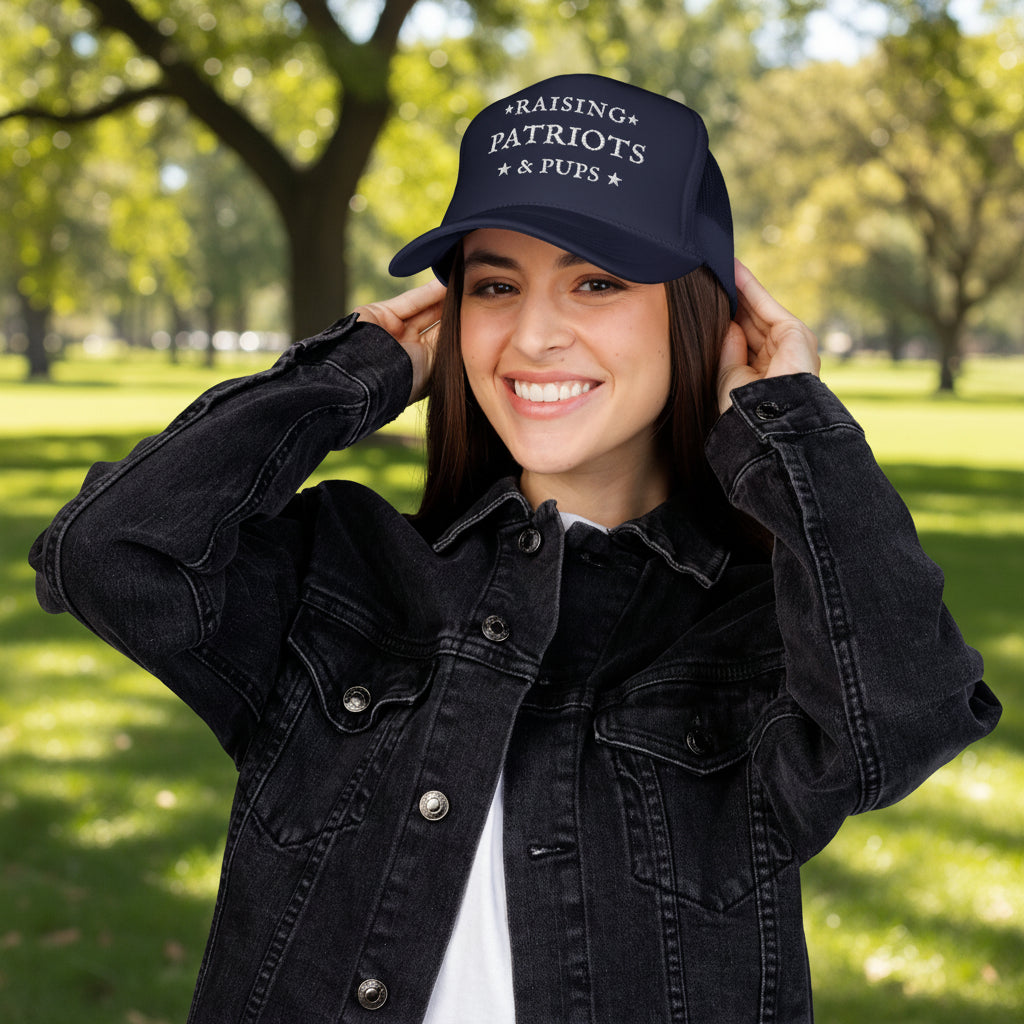 Person wearing a blue cap with text and a black denim jacket on a white background
