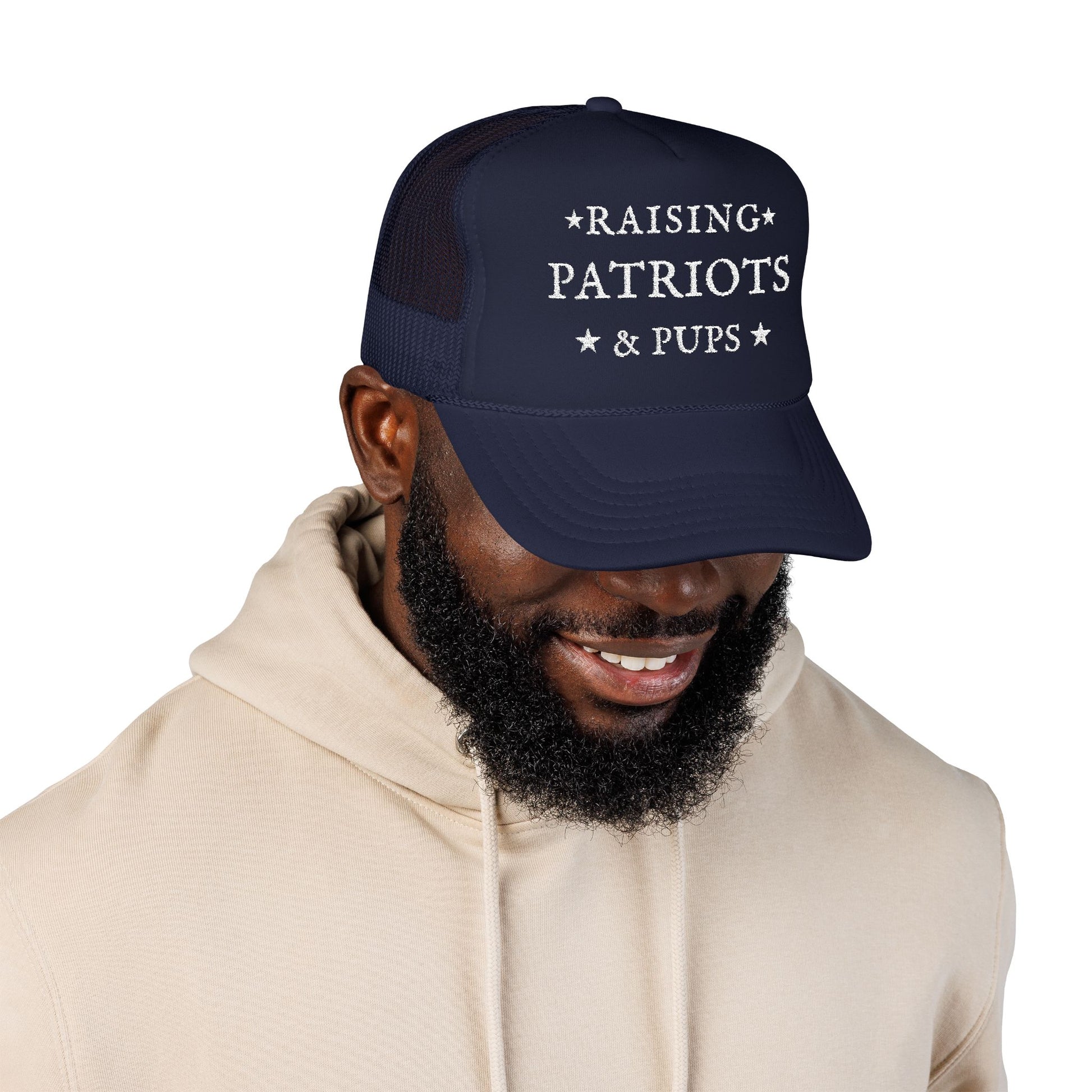 Man wearing a navy blue cap with 'Raising Patriots and Pups' text on a white background