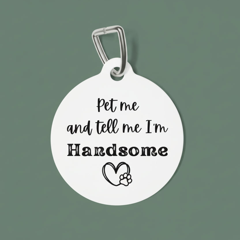 White pet tag with black text and paw print on a white background