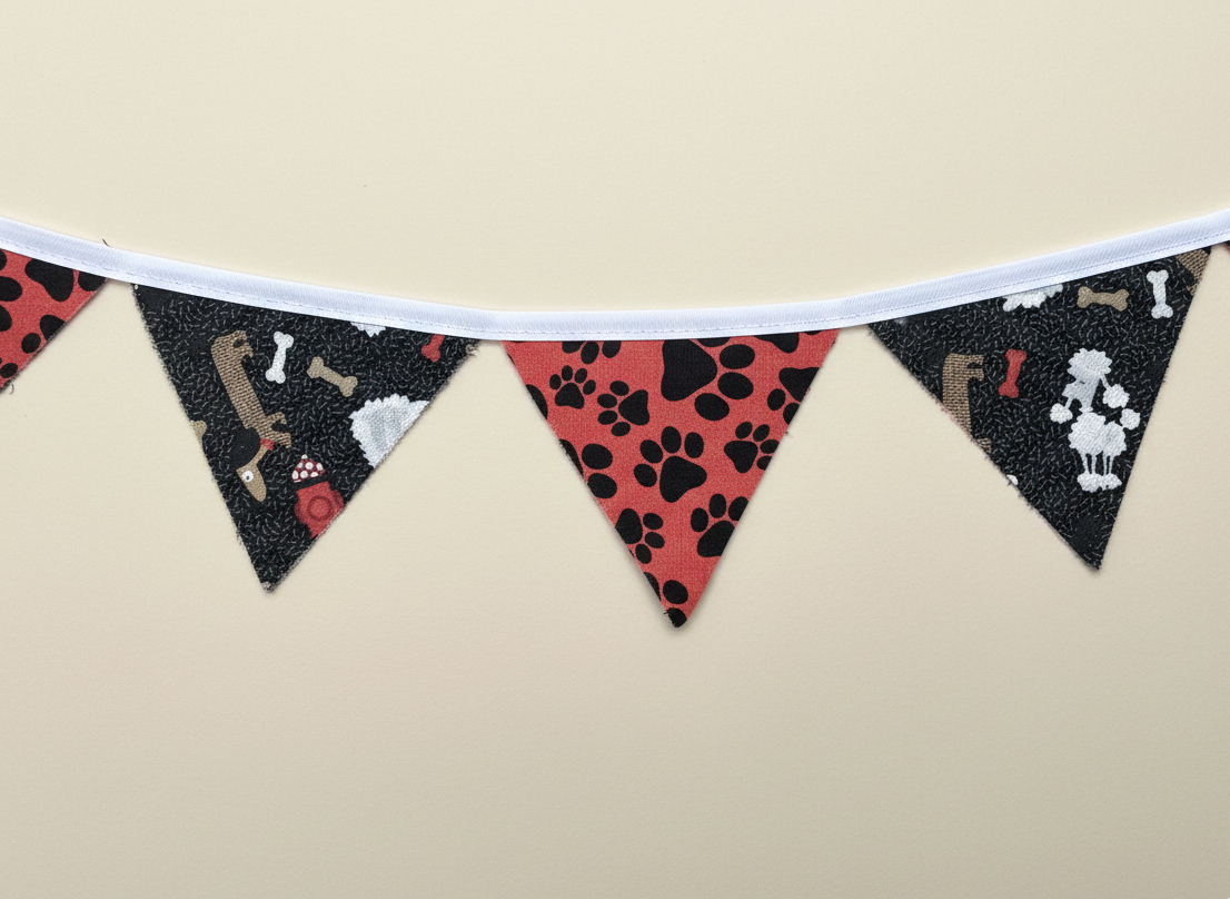 Dog-themed fabric banner with triangular flags on a beige background