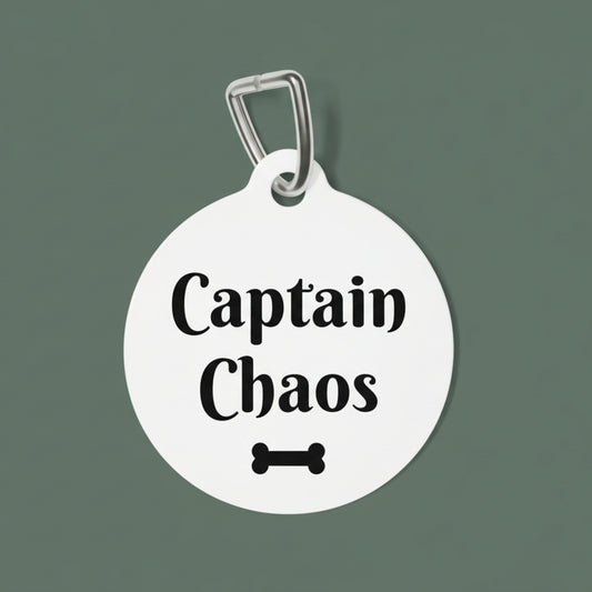 Round white pet tag with 'Captain Chaos' text and bone icon on a white background