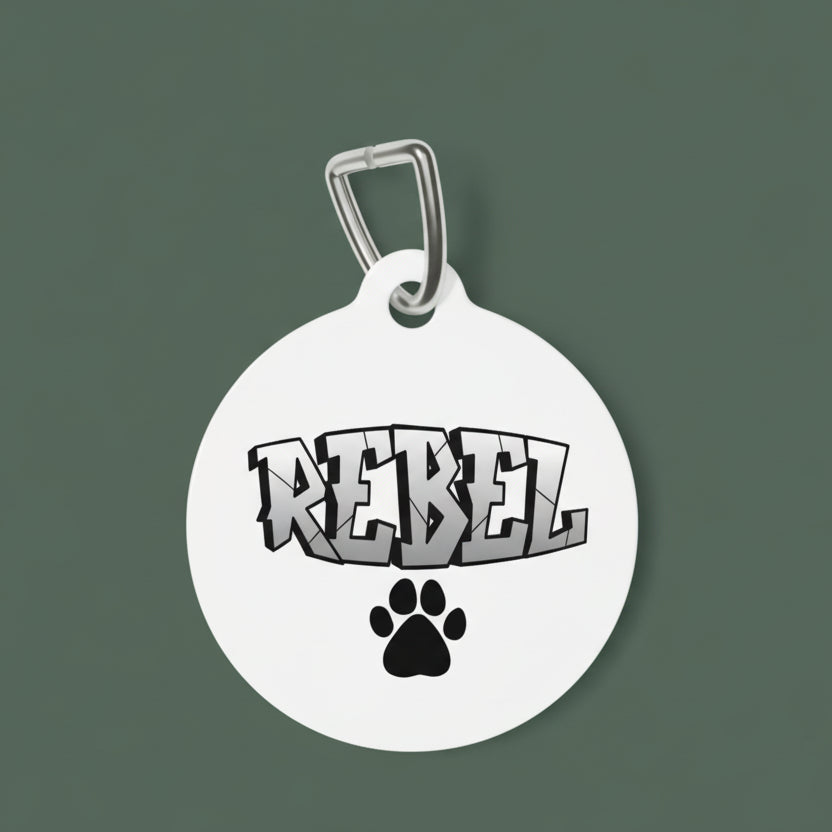 Round white pet tag with 'REBEL' in 3D look letters and a black paw print on a white background
