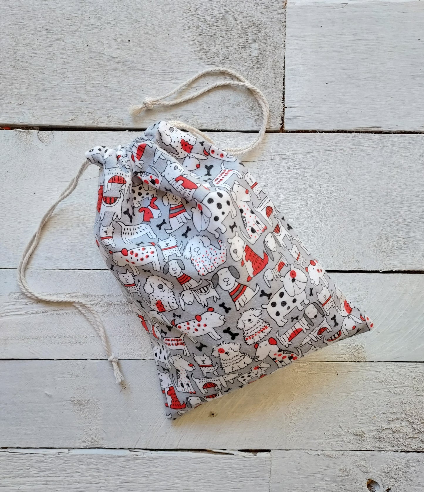 Drawstring bag with animal pattern on a wooden surface
