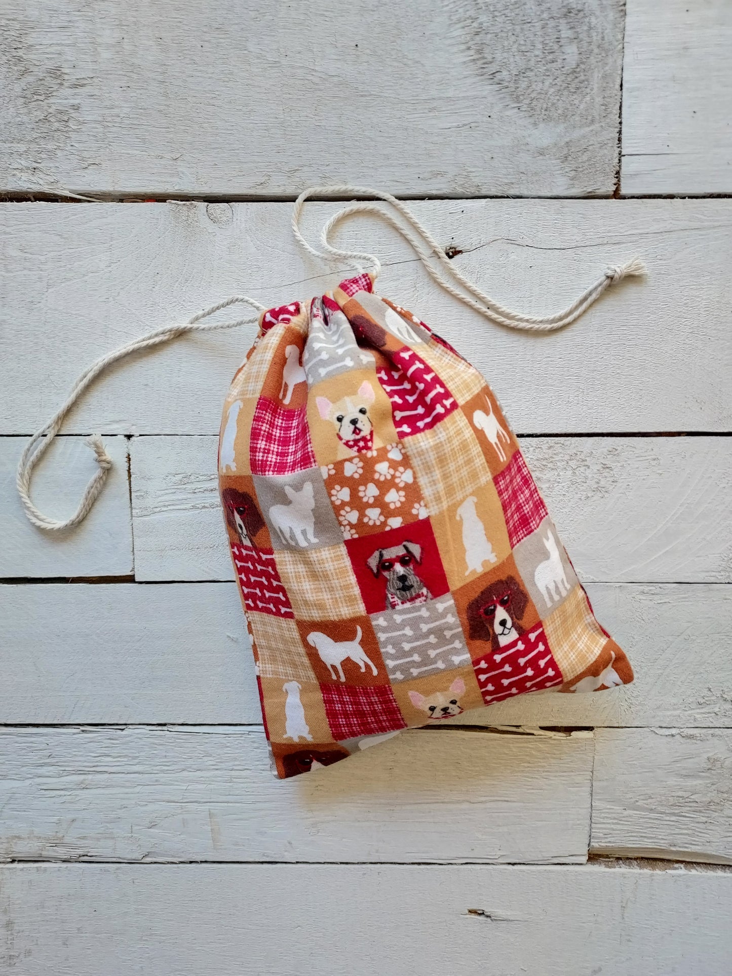 Patchwork drawstring gifts bag on a wooden surface