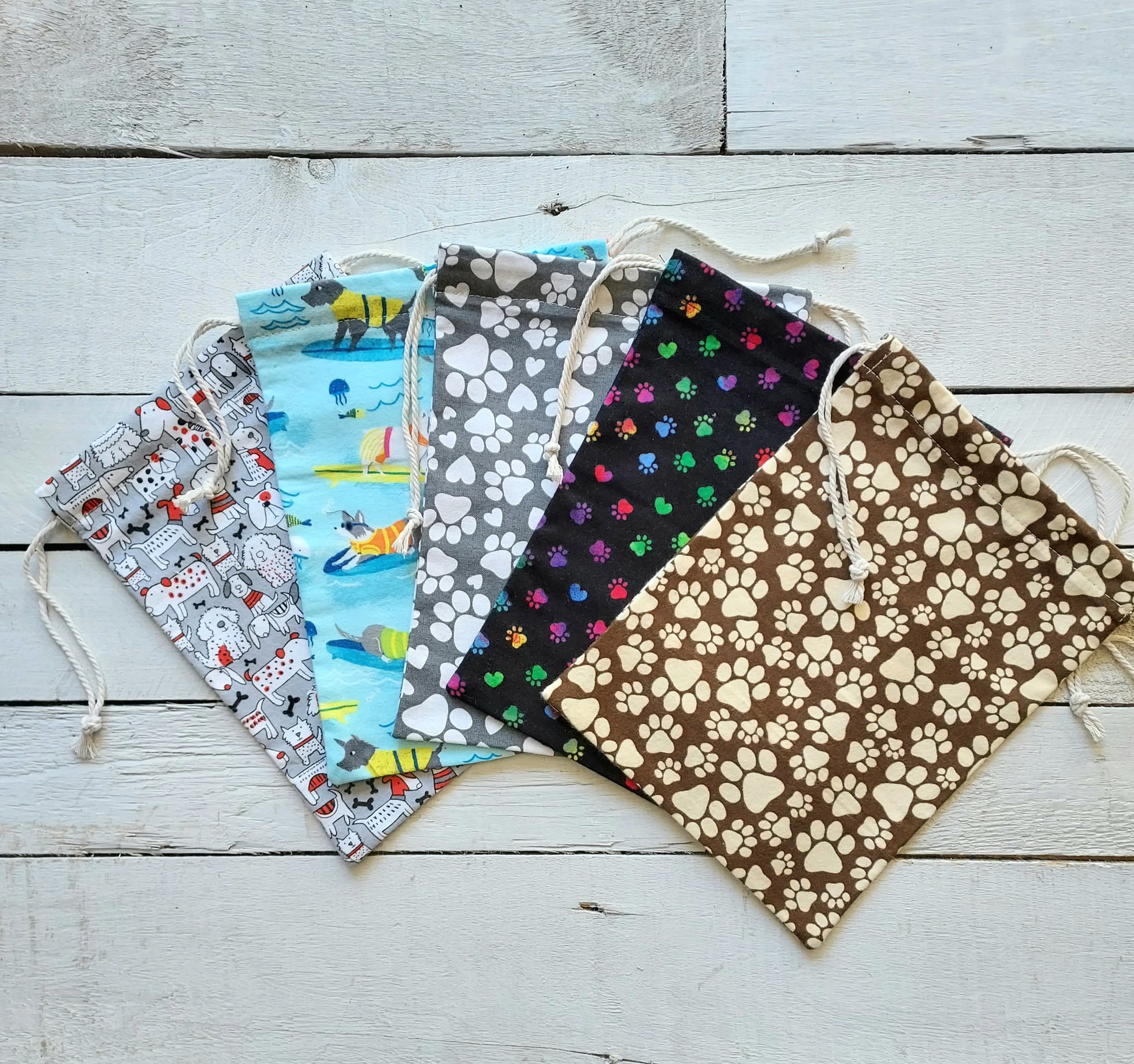 Five fabric bags with different patterns on a wooden surface