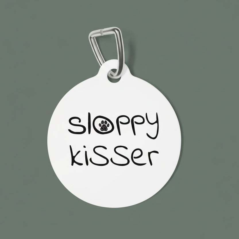 Round white dog tag with 'sloppy kisser' text on a white background