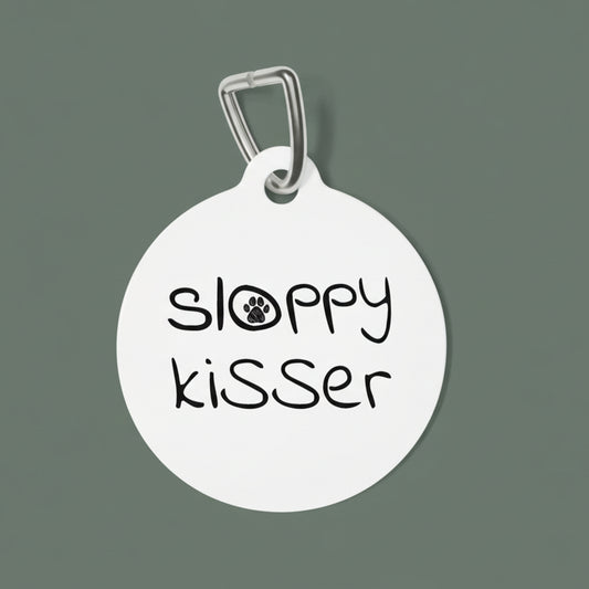 Round white dog tag with 'sloppy kisser' text on a white background